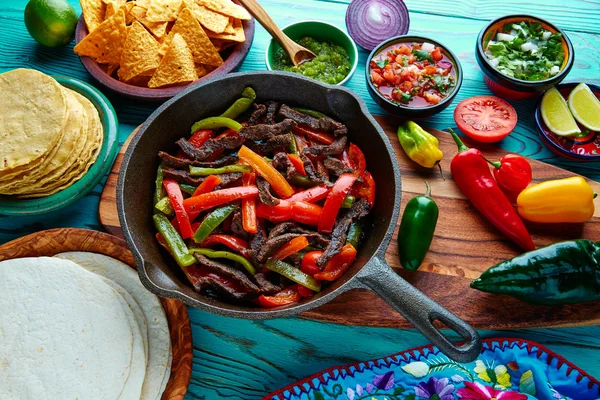 Beef fajitas in a pan sauces chili and sides Mexican — Stock Photo, Image