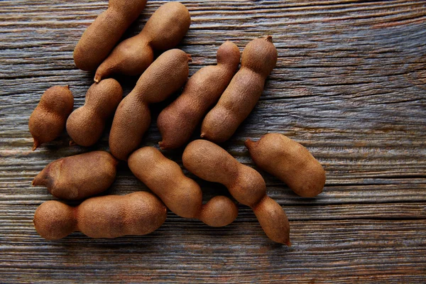 Tamarindo tamarindo frutas maduras em madeira marrom — Fotografia de Stock