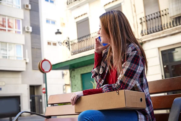 Young architect talking mobile sitting on bench — Stock Photo, Image