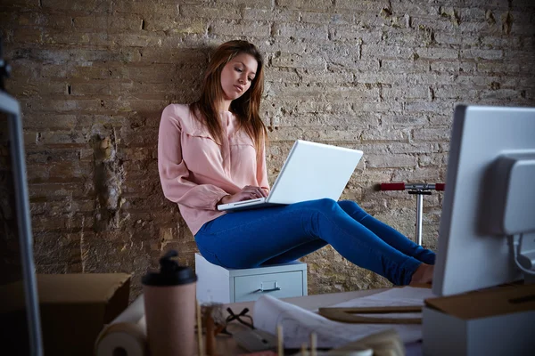 Businesswoman casual sitting at office with laptop — Stock Photo, Image