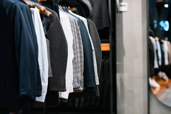 Pants in men\'s hands in a clothing store, close-up.