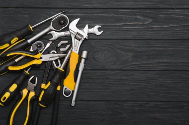 Set of assorted work carpentry and locksmith tools on a dark wooden background with copy space. clipart