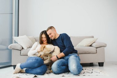 Guy ve kız arkadaşı yatak odasında dinleniyorlar. Mutlu çift evcil hayvanlarına bakar kim oynamak ister