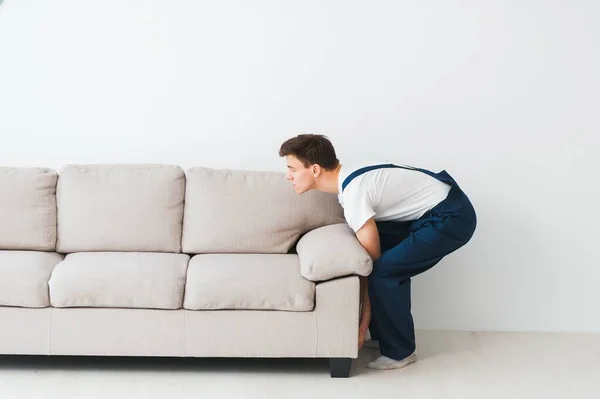 Loader Moves Sofa Couch Worker Overalls Lifts Sofa White Background — Stock Photo, Image