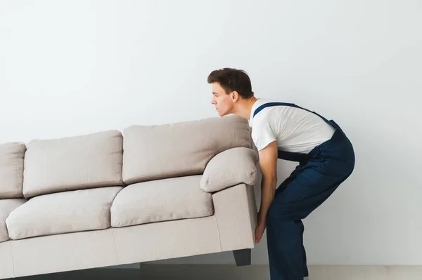 Loader Moves Sofa Couch Worker Overalls Lifts Sofa White Background — Stock Photo, Image