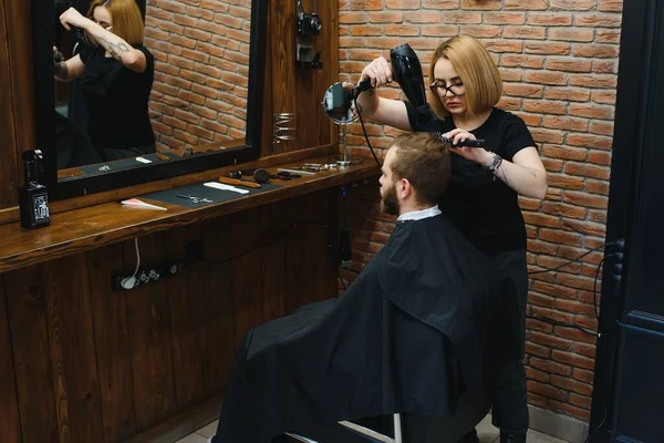 Barber Woman Cutting Man Hair at the Barbershop. Woman Working as a Hairdresser. Small Business Concept.