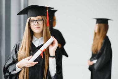 Mezuniyet töreninde sınıf arkadaşlarıyla güzel bir bayan üniversite mezunu.