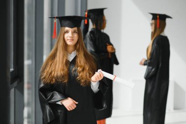 Mezuniyet töreninde sınıf arkadaşlarıyla güzel bir bayan üniversite mezunu.