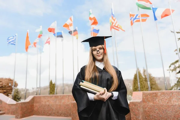 Educational theme: graduating student girl in an academic gown.