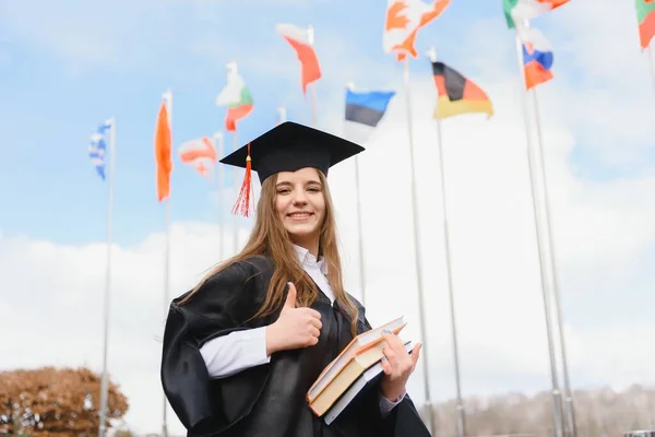 Educational theme: graduating student girl in an academic gown.