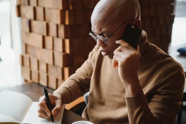 Portrait of a guy using mobile phone and laptop