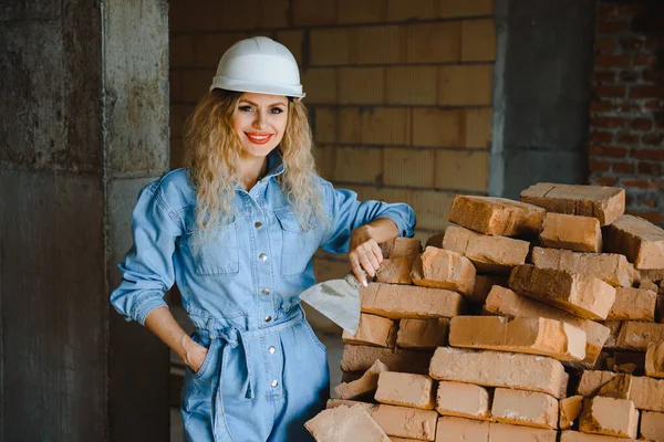 Warehouse woman worker. Woman builder in hardhat. Girl engineer or architect. Home renovation. Quality inspector. Construction job occupation. Construction worker. Lady at construction site.