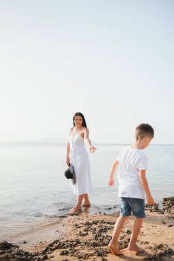 Mutlu anne ve oğul okyanus sahilinde yürüyüp Pandawa Sahili, Bali 'de harika bir aile tatili geçiriyorlar. Cennet, seyahat, tatil konsepti