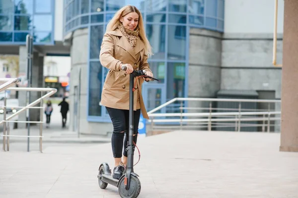 Portrait of a young woman with electro scooter