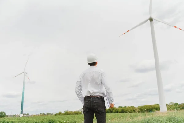 Windmill engineer inspection and progress check wind turbine at construction site.