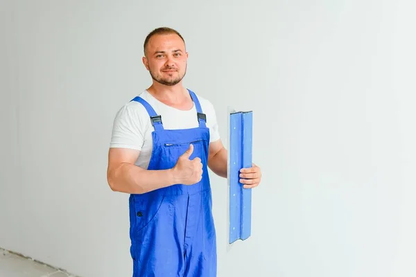 Portrait Worker Overalls Holding Putty Knife His Hands Plastered Wall — Stock Photo, Image