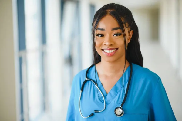 肖像画自信を持ってアフリカ系アメリカ人女性医師医療専門家が病院の廊下の窓の背景に隔離された患者ノートを書く 正の表情 — ストック写真