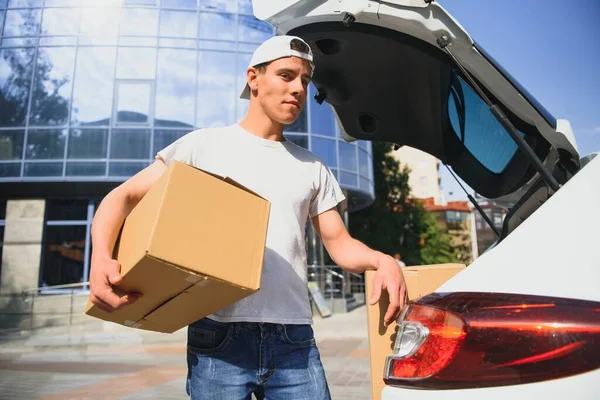 Smiling Delivery Man Holding Paper Box — Stock Photo, Image