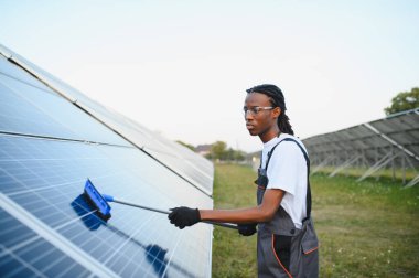 Fotovoltaik güneş paneli temizleyen işçiler, sürdürülebilir yeşil enerji üretimi ve çevresel destek için optimal performans sağlıyorlar