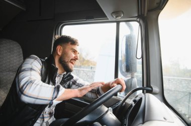 Kamyon şoförü yolda büyük bir kamyon kullanırken öfkesini göstermek için kornaya basıyor. Stresli yolculuk ve yol kavgası