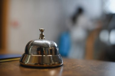 Metal call bell placed on a reception desk, ready for a guest to ring for assistance or check in service