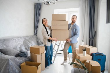 Mutlu çift yeni evlerine taşınıyorlar, kutuları taşıyorlar. Konseptler, gayrimenkul, taşınma, ilk ev, mülk