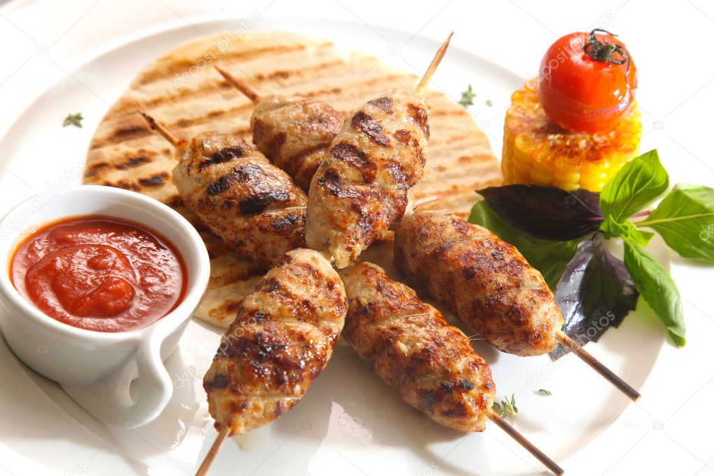 grilled meat on a stick with souce