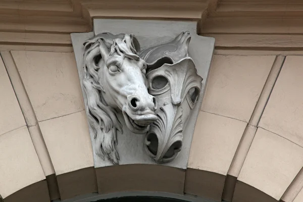 horse head sculpture and masks on wall
