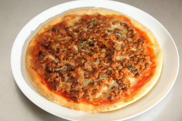 Pizza with meat and cheese