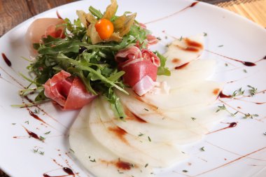 Arugula salatası ve tabakta kavun.