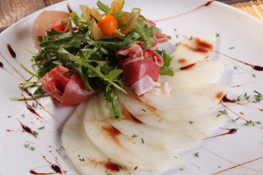 Arugula salatası ve tabakta kavun.