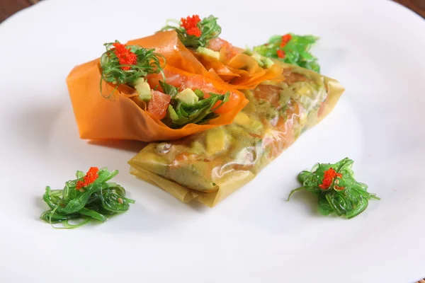 spring rolls with vegetables from the food paper on plate