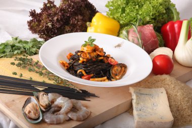 Black spaghetti with seafood on plate