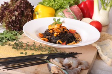 Black spaghetti with seafood on plate