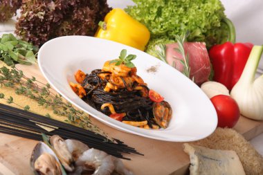 Black spaghetti with seafood on plate