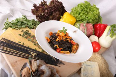 Black spaghetti with seafood on plate