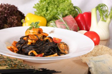 Black spaghetti with seafood on plate
