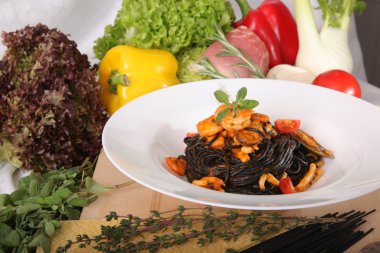 Black spaghetti with seafood on plate