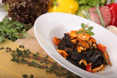 Black spaghetti with seafood on plate