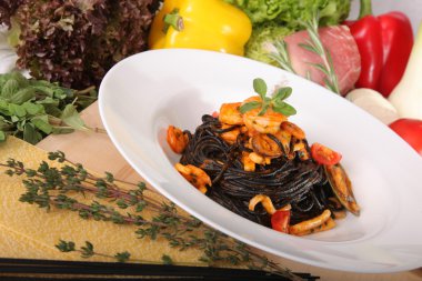 Black spaghetti with seafood on plate