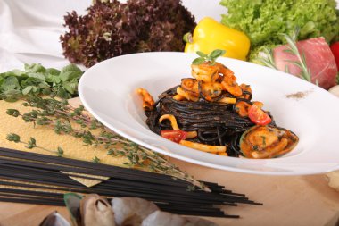 Black spaghetti with seafood on plate