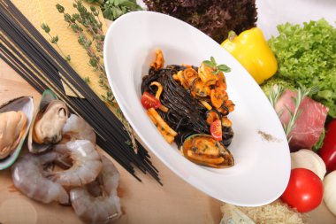 Black spaghetti with seafood on plate