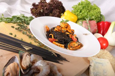 Black spaghetti with seafood on plate