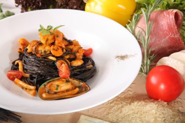 Black spaghetti with seafood on plate