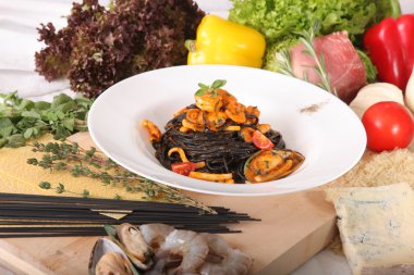 Black spaghetti with seafood on plate