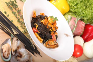 Black spaghetti with seafood on plate