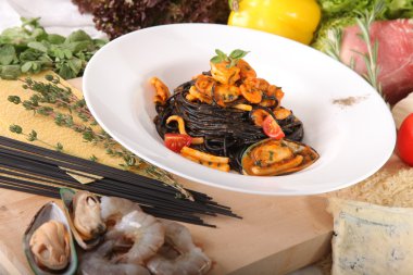 Black spaghetti with seafood on plate