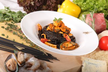Black spaghetti with seafood on plate