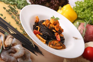 Black spaghetti with seafood on plate