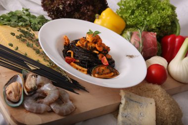 Black spaghetti with seafood on plate